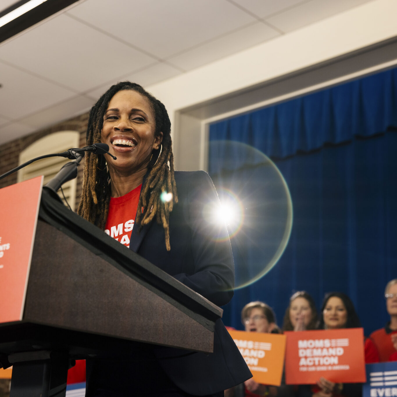 A photo of Moms Demand Action Executive Director, Angela Ferrell-Zabala, speaking to a crowd.