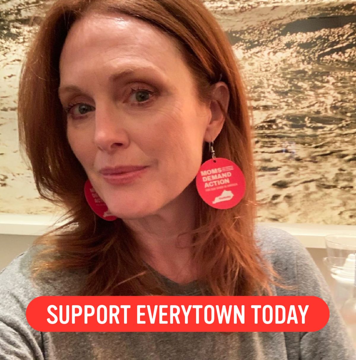 A photo of actress Julianne Moore wearing Moms Demand Action earrings and a red button that says "Support Everytown today"