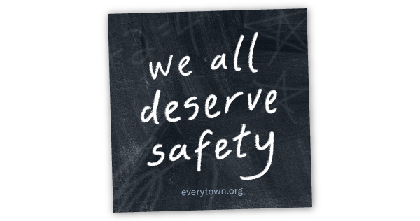 "we all deserve safety" in handwritten white chalk letters over black chalkboard background